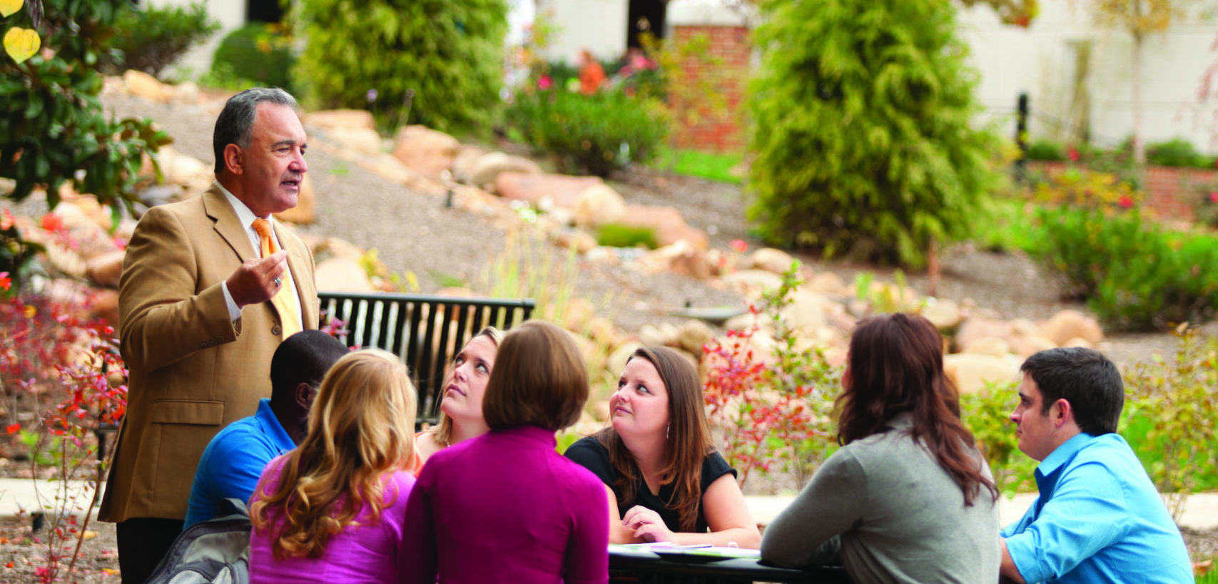 Dean Emeritus Bob Rider teaching students outside.